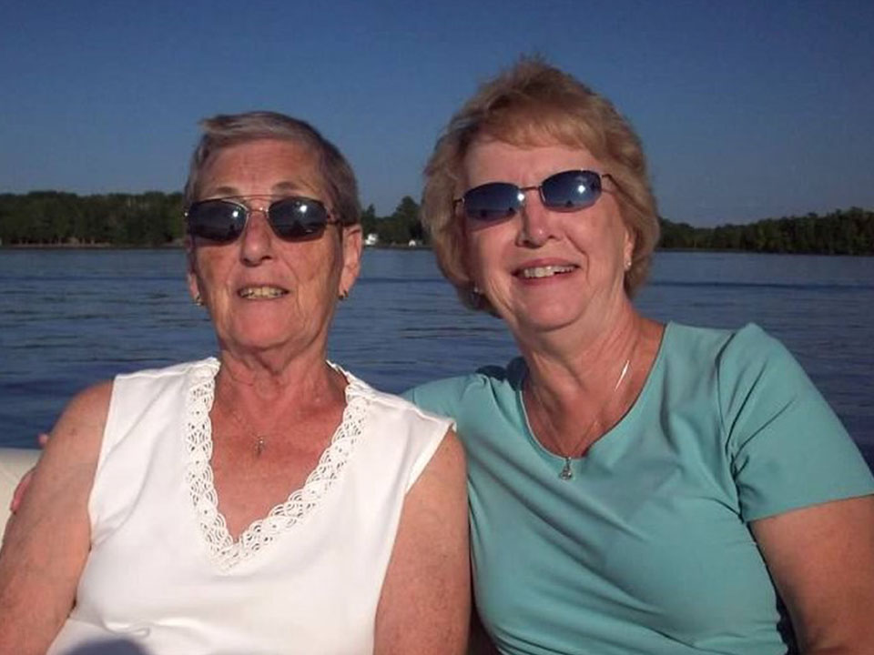 Two women on a pontoon sitting together