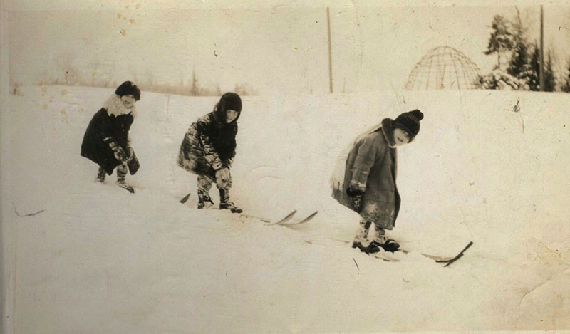 1926 photo of young children skiing down a hill