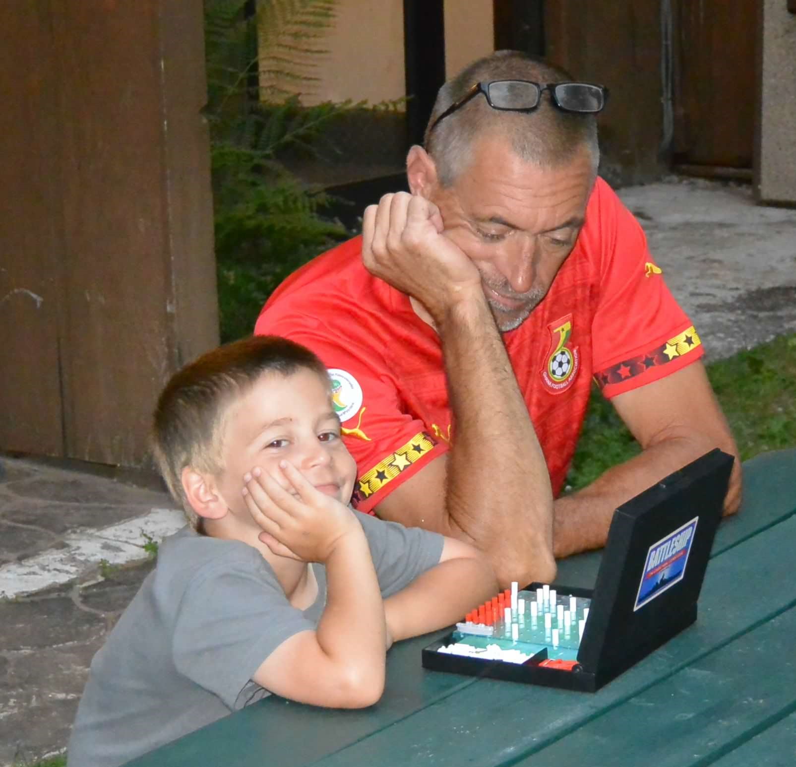 Grandparent and child playing battleship game