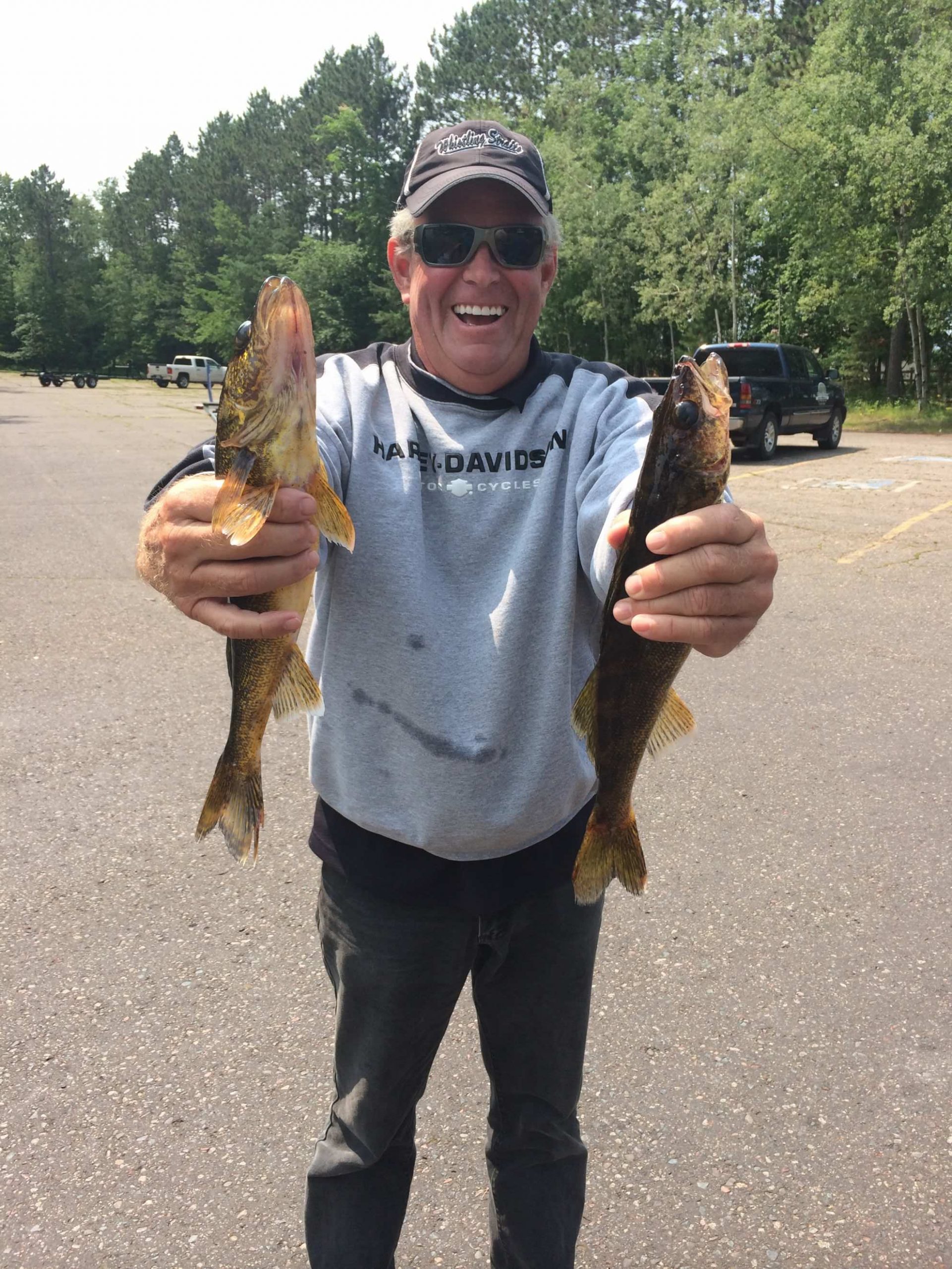 man holding two fish