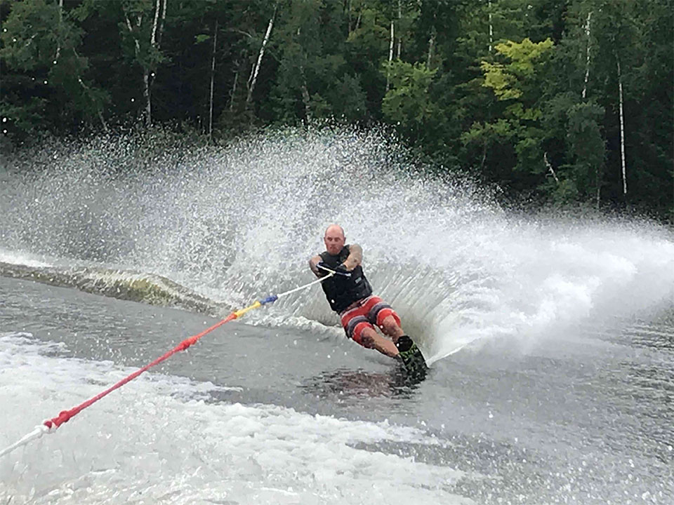 man waterskiing on the lake