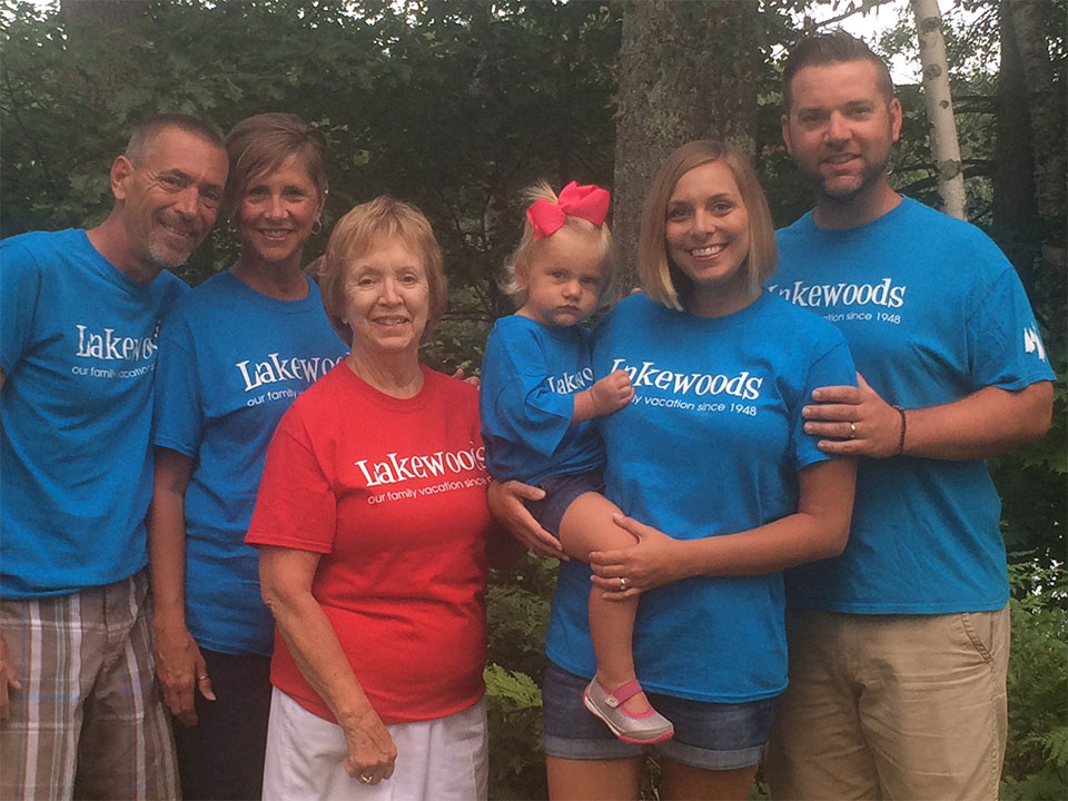 Family with Lakewoods t-shirts posing together.