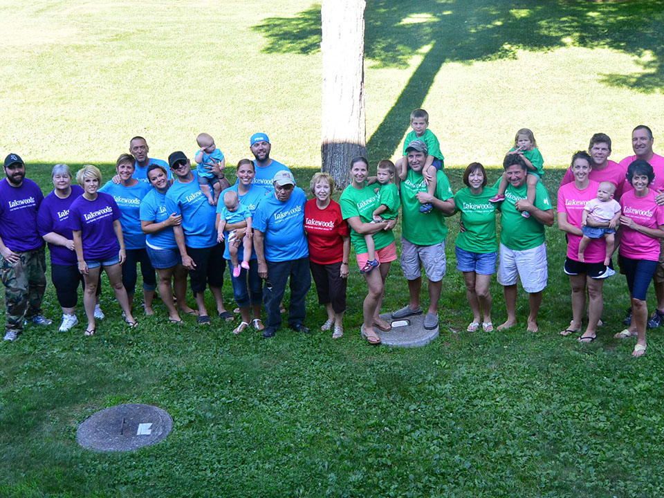 Large group photo of multiple families in different colored Lakewood shirts.