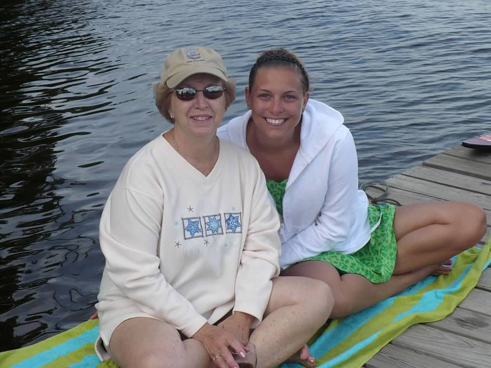 Mother and daughter sitting on the dock