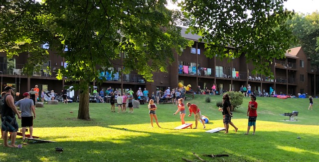 groups playing cornhole on condo lawn