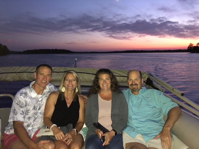 Two couples on a pontoon at sunset