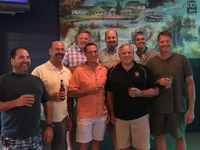 Men standing together posing for a photo