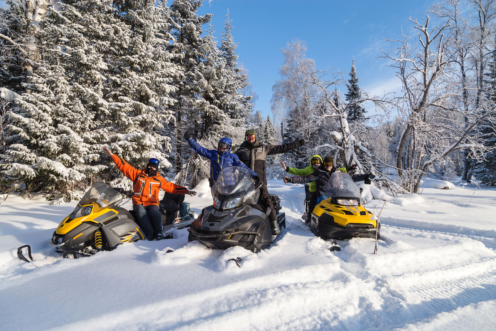 snowmobiles on trail during nice sunny day