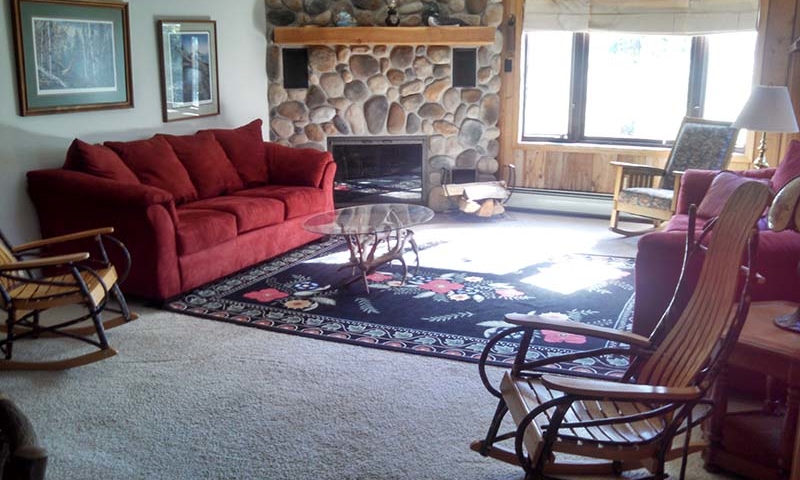 cabin living room with fireplace, rocking chairs
