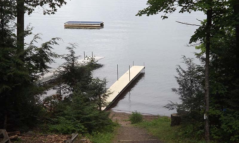 view of lake and pier from deck