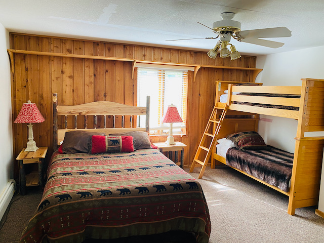 cabin bedroom with queen bed and bunkbed