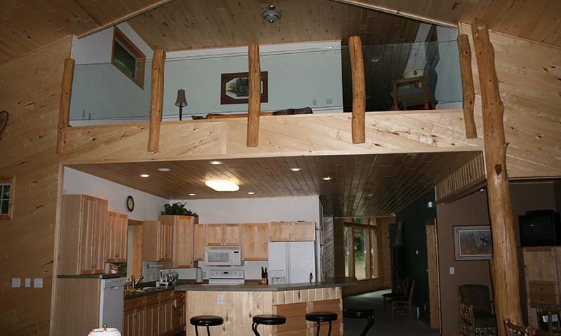 Cabin kitchen with breakfast bar, view of loft