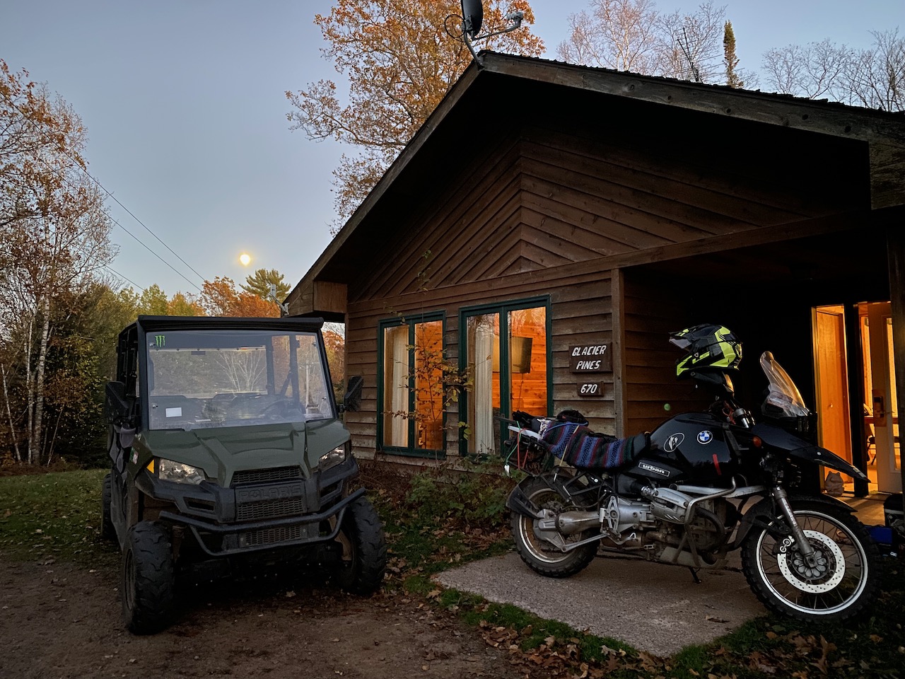 UTV and Motorcycle parked outside of cabin
